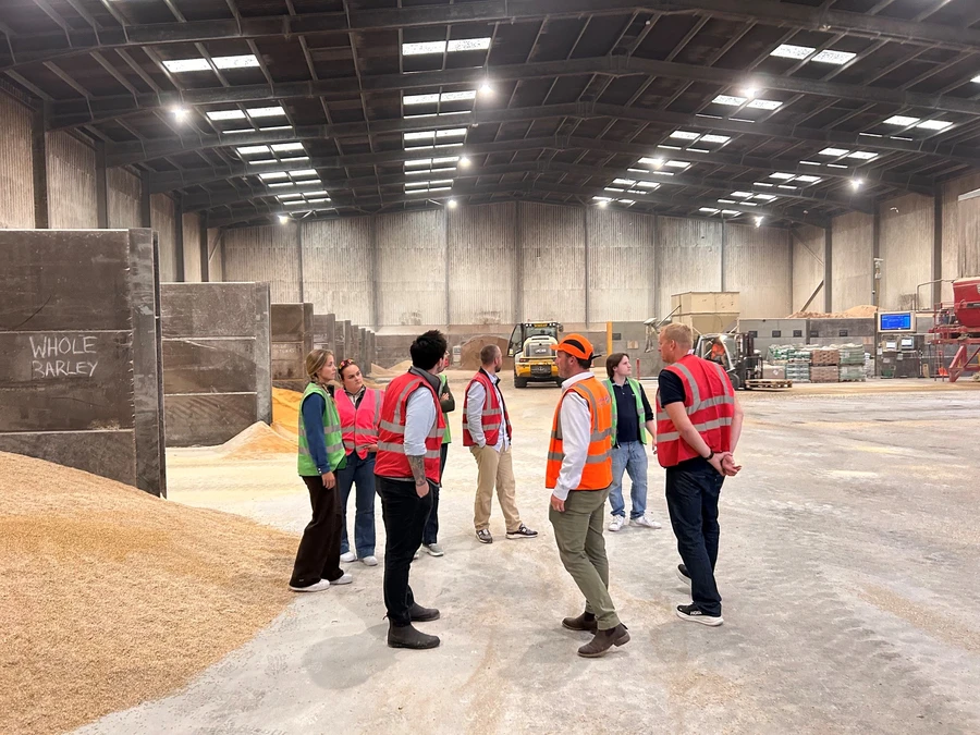 grain-processing-mill-team-tour Team touring a grain processing mill and storage facility